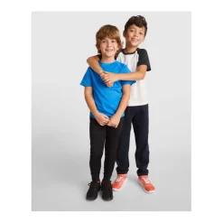 Gift Campaign Pantaloni per bambini con vita elastica in poliestere 220 g/m2 Roly></noscript> Pantaloni